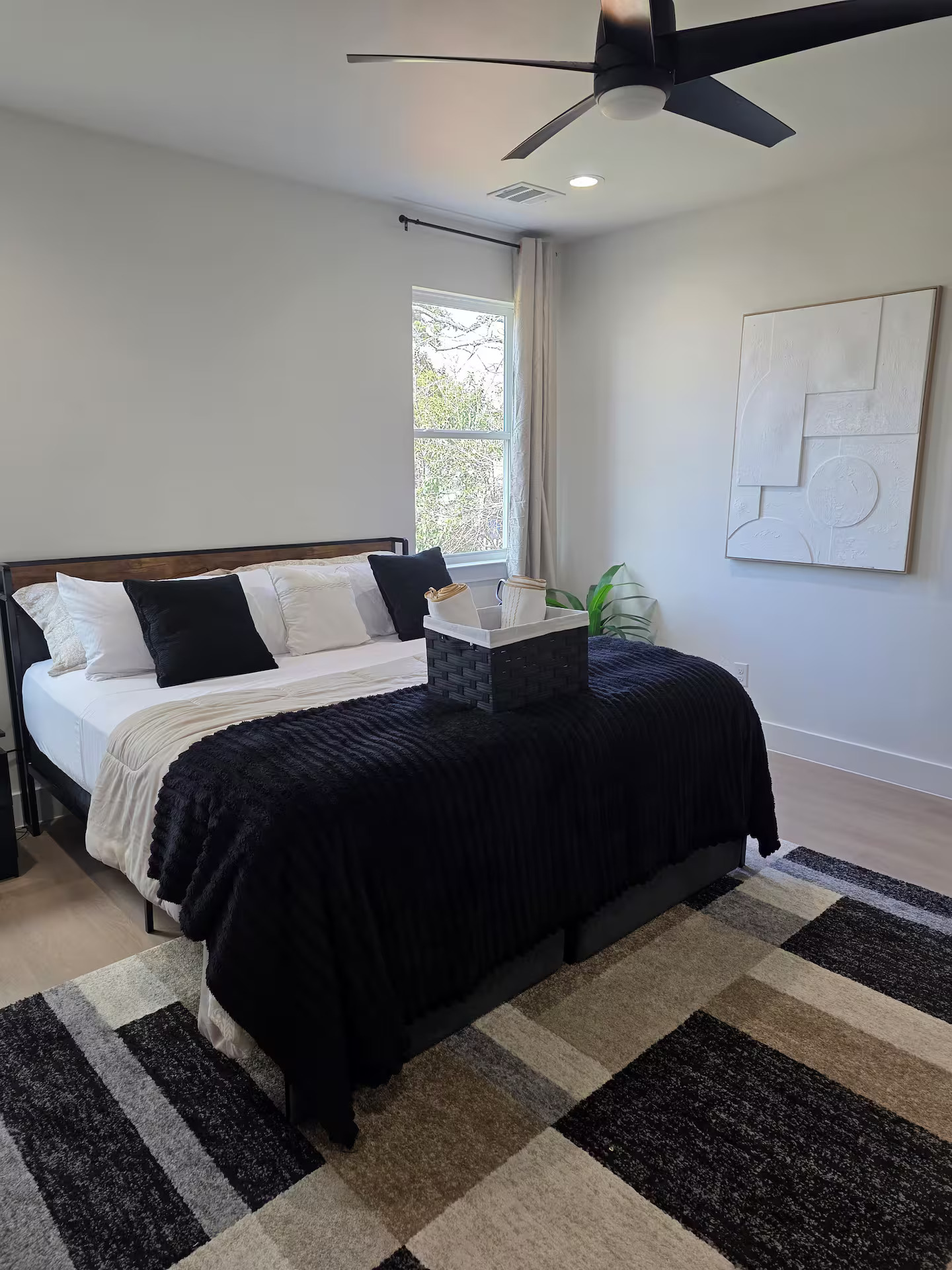 Bedroom with morning light and ceiling fan